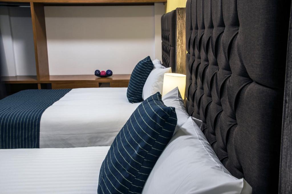 Postel nebo postele na pokoji v ubytování Hotel Casa Aurora