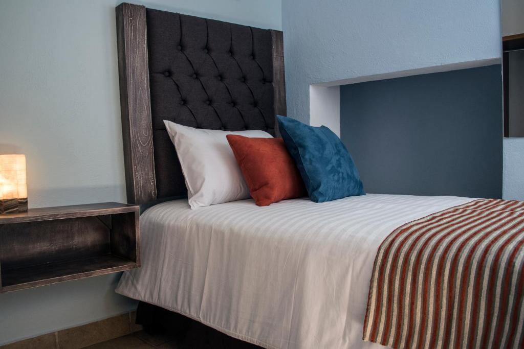 Postel nebo postele na pokoji v ubytování Hotel Casa Aurora