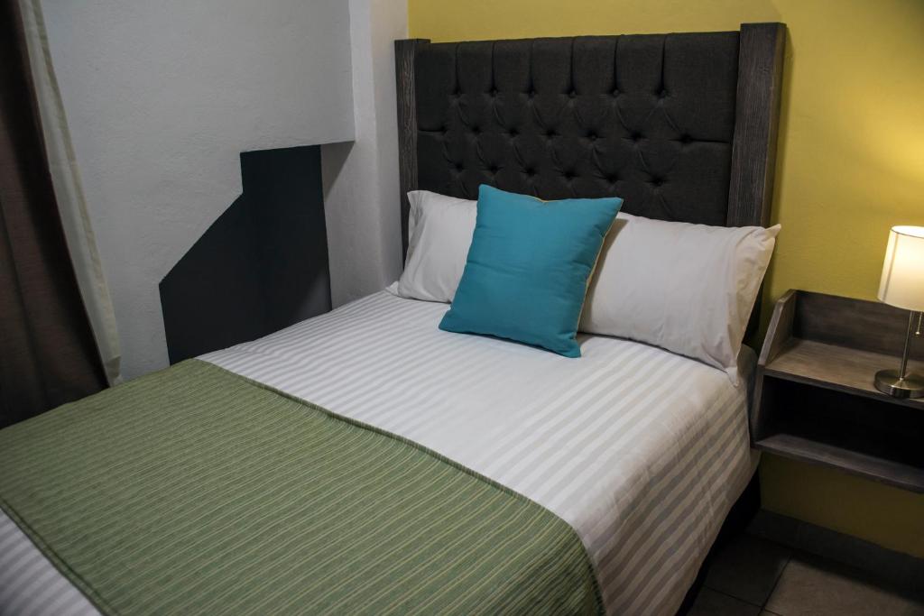 Postel nebo postele na pokoji v ubytování Hotel Casa Aurora
