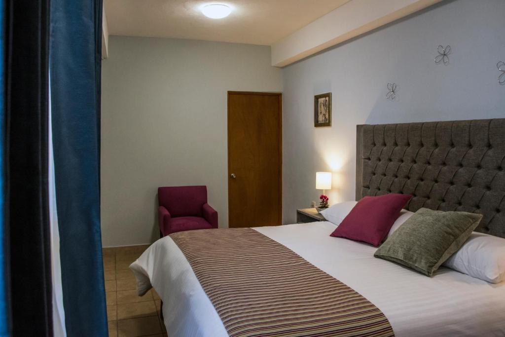 Postel nebo postele na pokoji v ubytování Hotel Casa Aurora