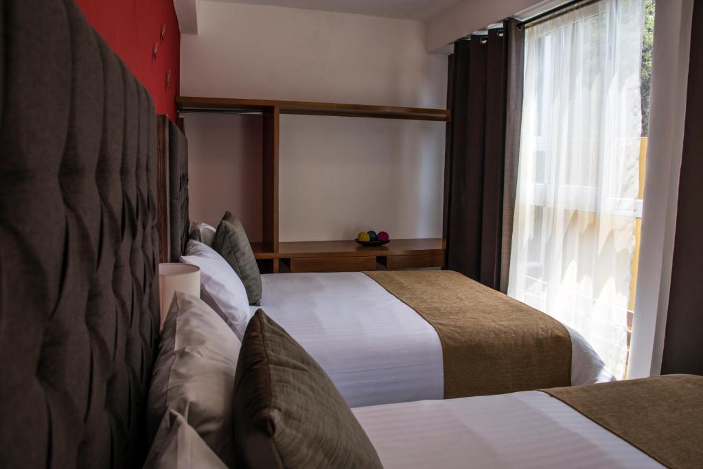 Postel nebo postele na pokoji v ubytování Hotel Casa Aurora