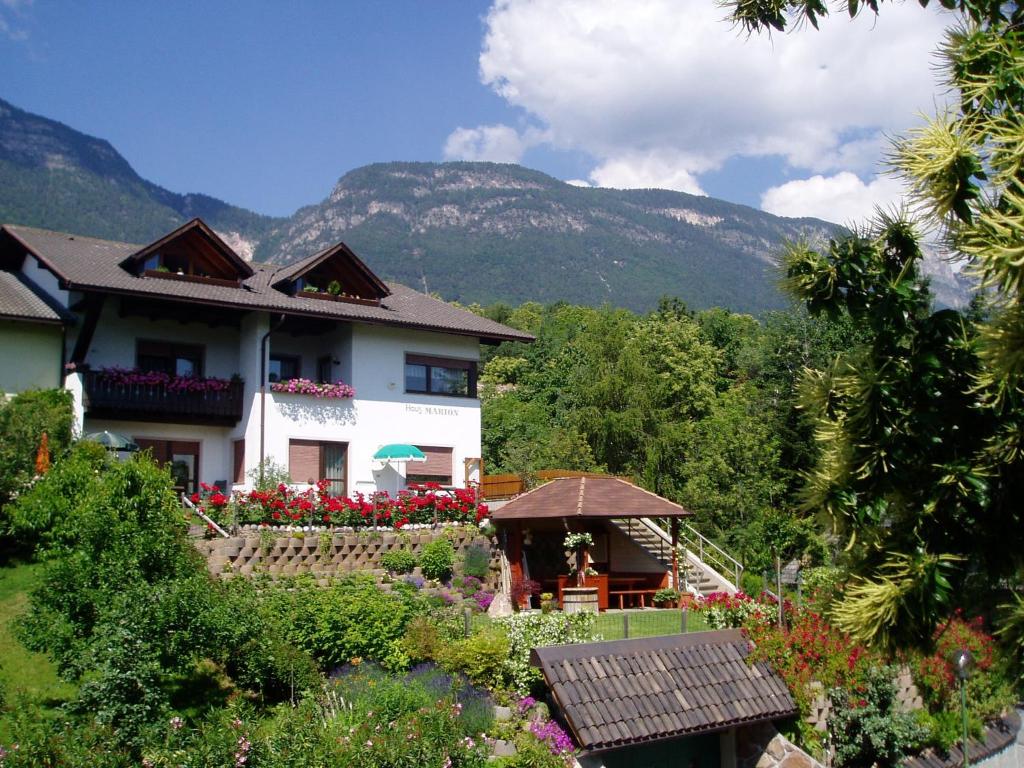 a house with a gazebo in front of a mountain at Haus Marion in Appiano sulla Strada del Vino