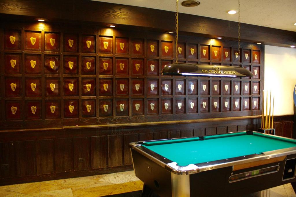 a pool table in a room with a wall of wood at Congress Plaza Hotel Chicago in Chicago