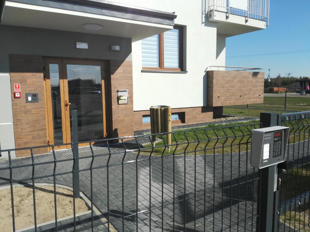 a house with a fence in front of it at Apartamenty Pisz in Pisz