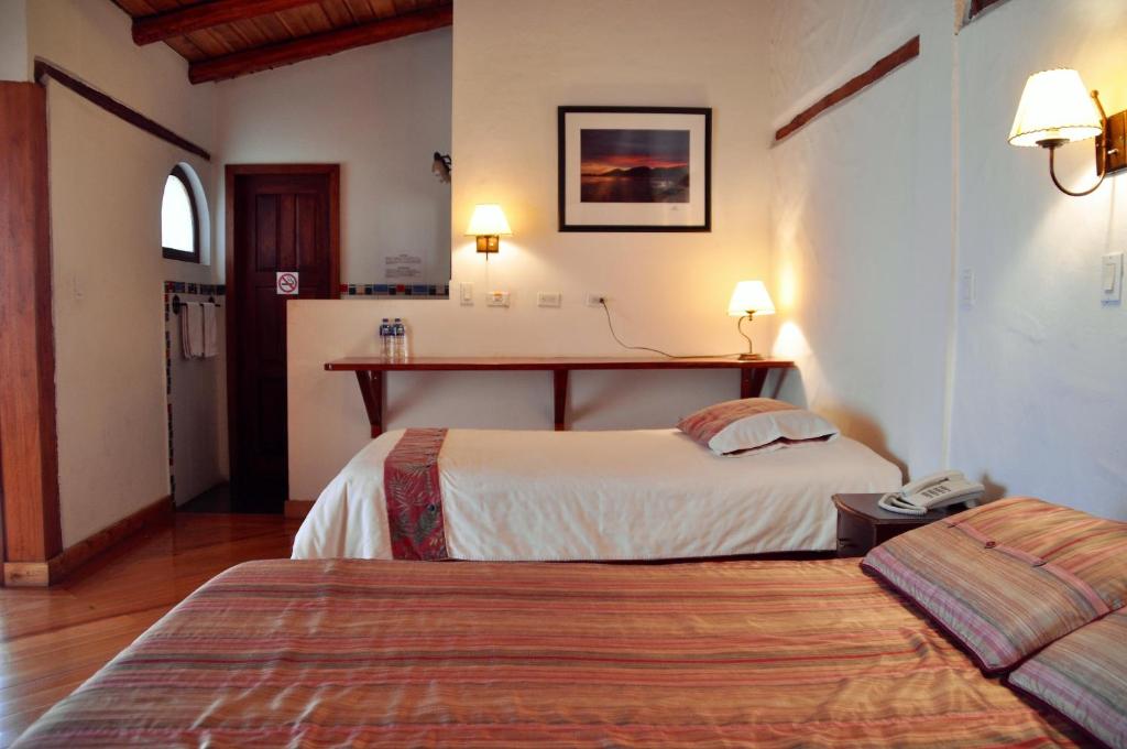 Postel nebo postele na pokoji v ubytování Boutique Hotel Casa Foch