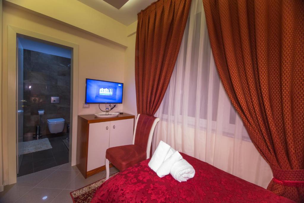 Postel nebo postele na pokoji v ubytování Vila Tako - Hotel