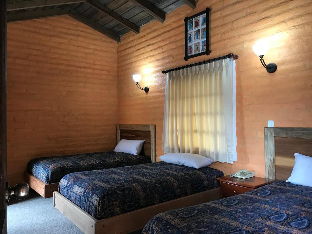 Postel nebo postele na pokoji v ubytování Hotel y Hosteria Natabuela