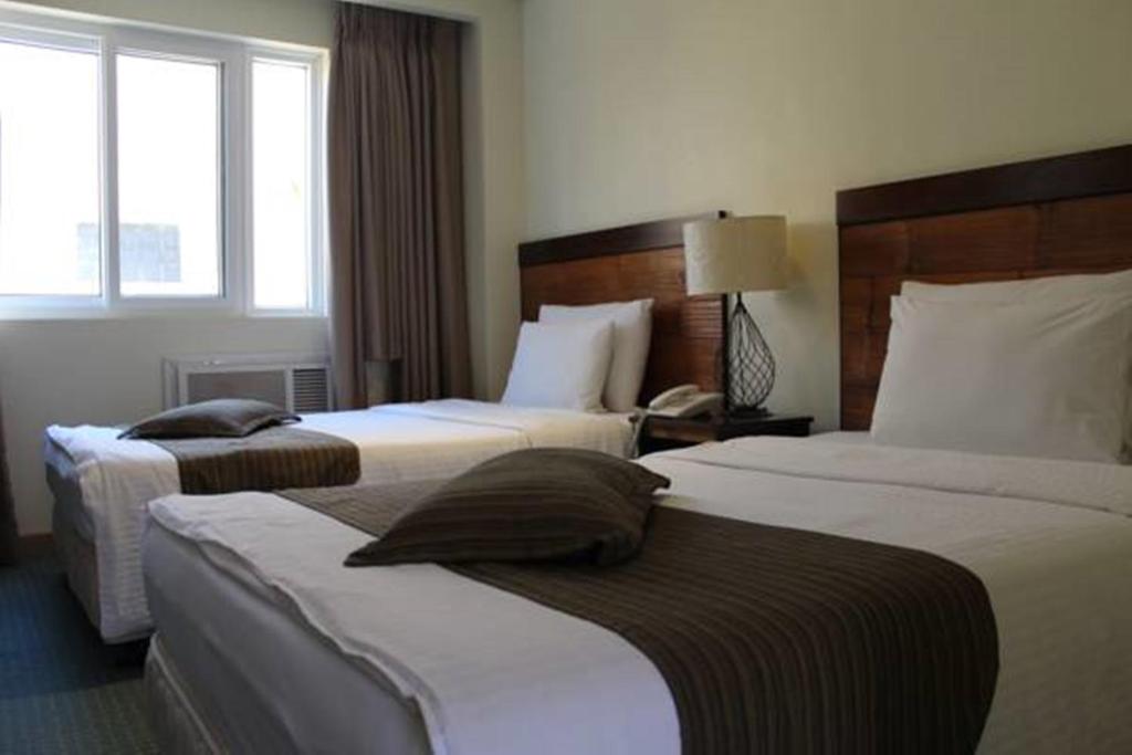 Postel nebo postele na pokoji v ubytování Boracay Sands Hotel