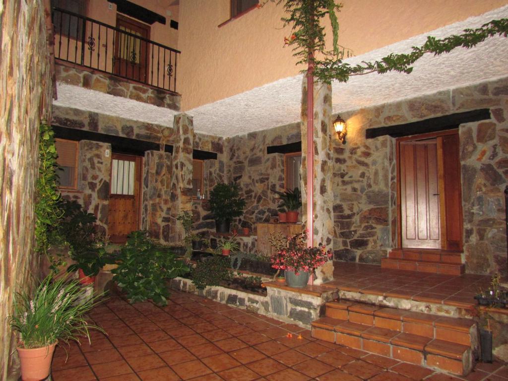 a stone building with a porch and a door at Apartamentos Rurales Azabal in Azabal