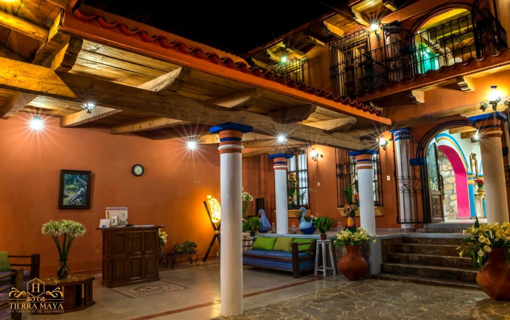 a large room with a building with columns and lights at Hotel Tierra Maya in San Cristóbal de Las Casas
