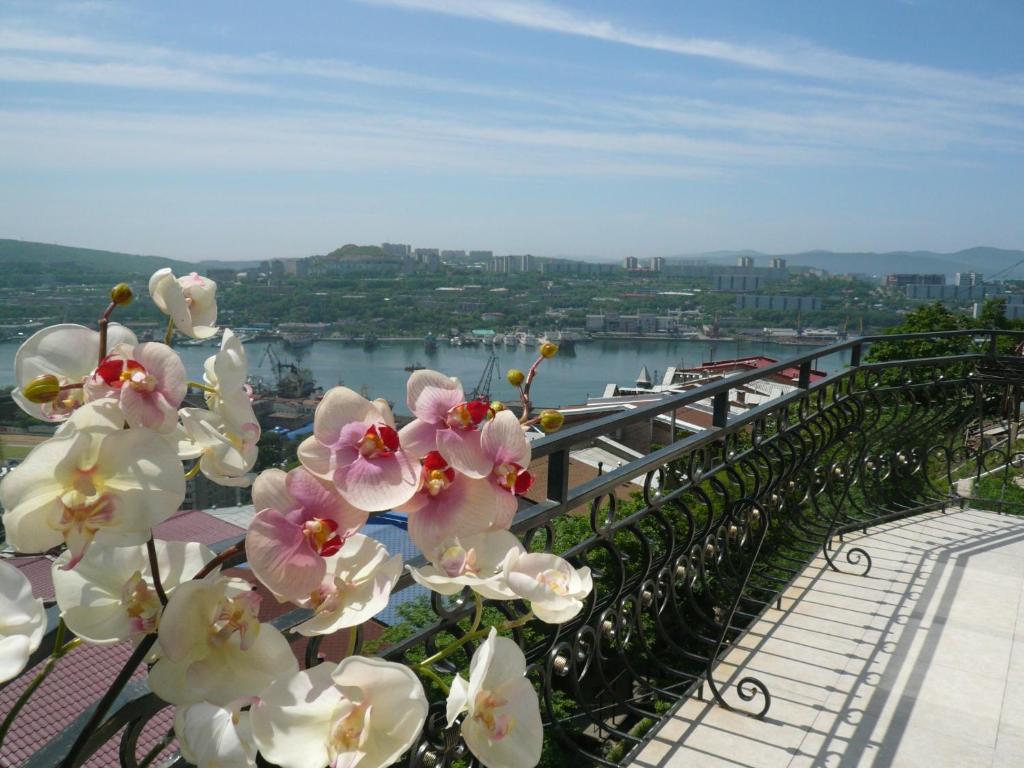 a bunch of pink and white flowers on a balcony at Aquilonis in Vladivostok