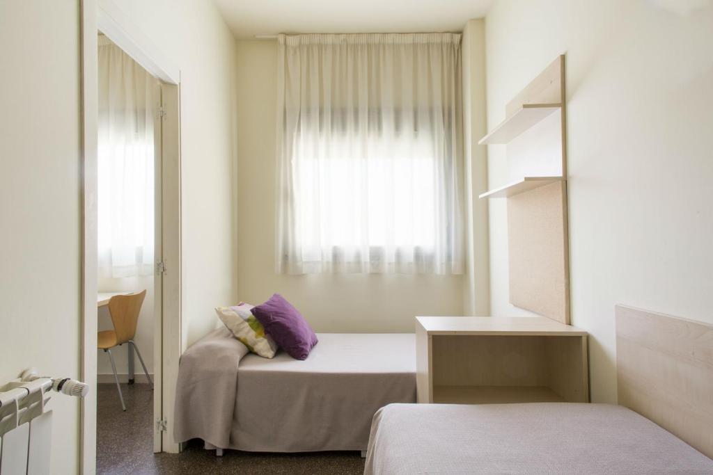 Postel nebo postele na pokoji v ubytování Residencia Universitaria Resa Los Abedules