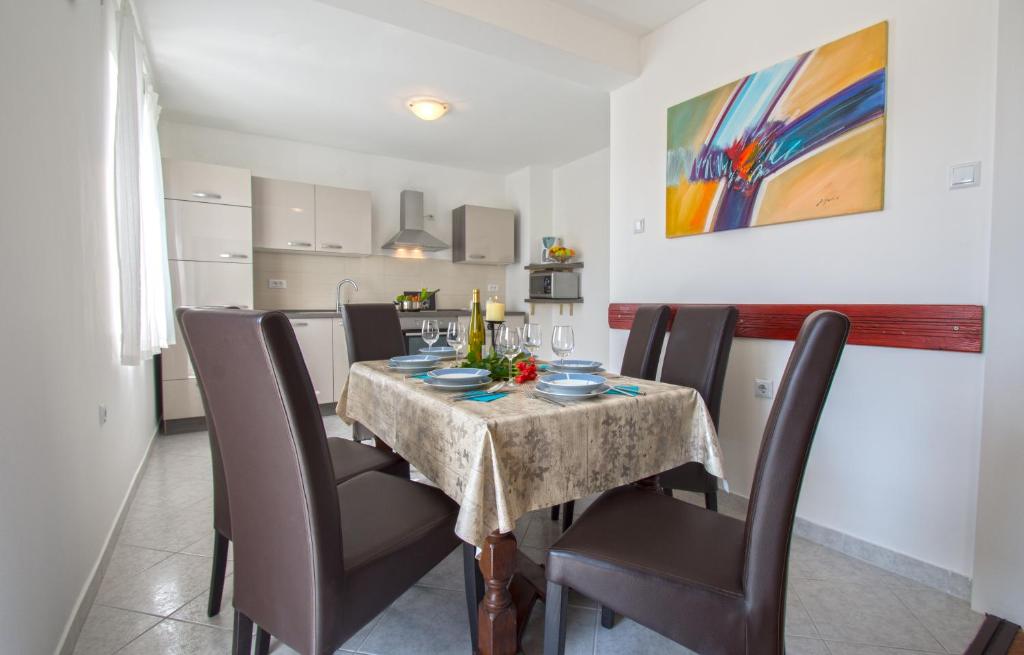 comedor con mesa y sillas y cocina en Apartment Marty, en Crikvenica