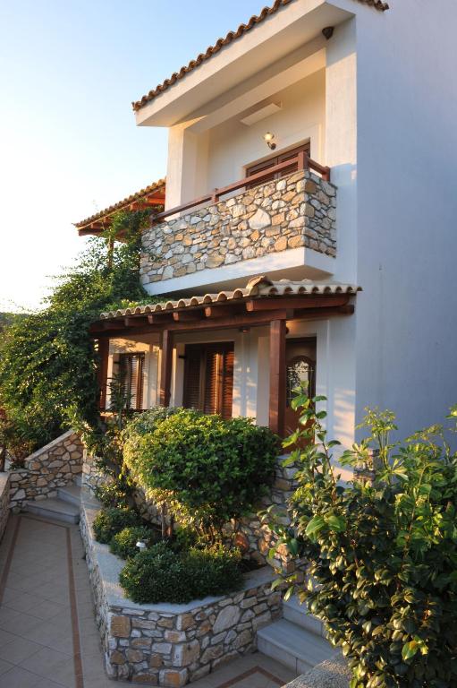 a house with a stone staircase leading up to it at Villa Maraki in Agia Paraskevi