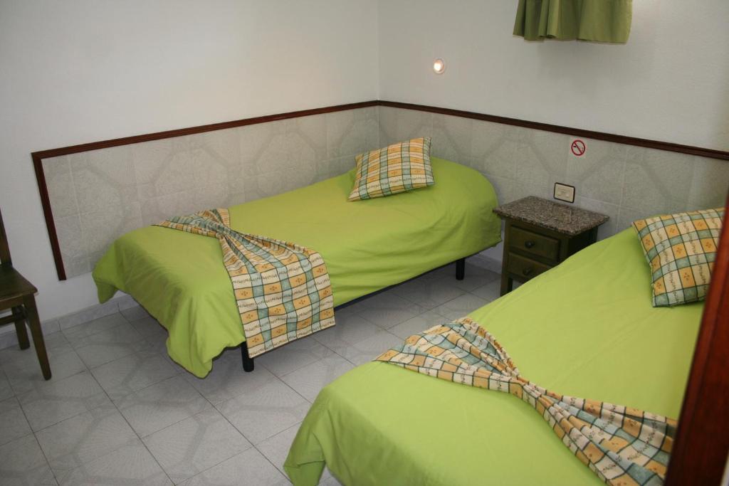A bed or beds in a room at Apartamentos Maba Playa