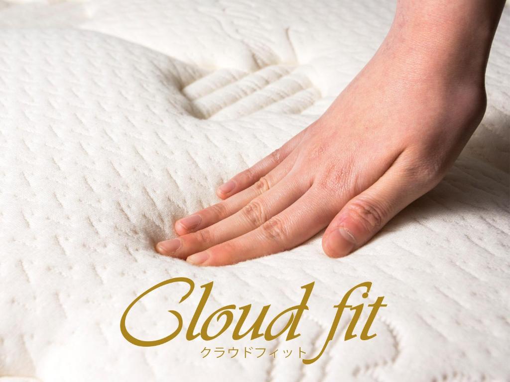 a picture of a hand on a white mattress at APA Hotel Shibuya Dogenzakaue in Tokyo