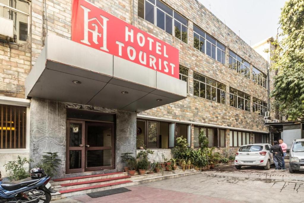 a hotel with a sign on the front of a building at Hotel The Tourist - 1 min from New Delhi Railway Station in New Delhi