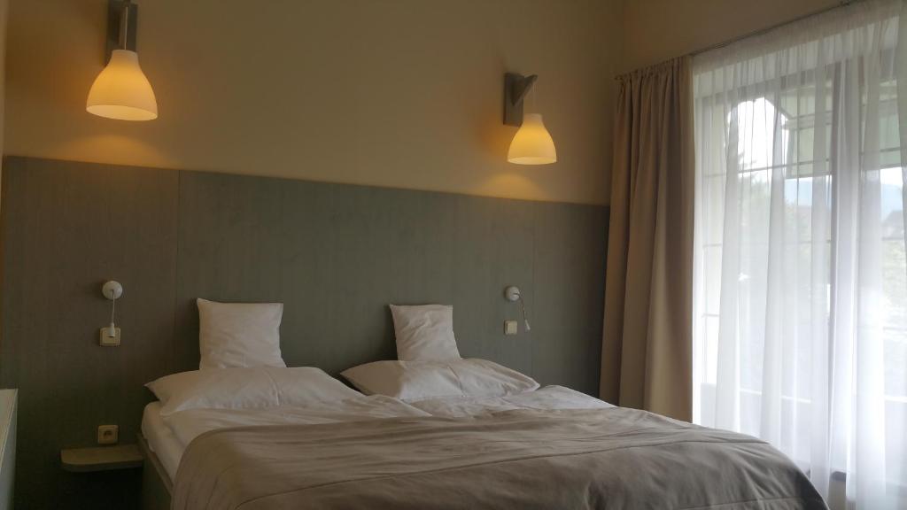 Postel nebo postele na pokoji v ubytování Hotel Výpřež - Děčín