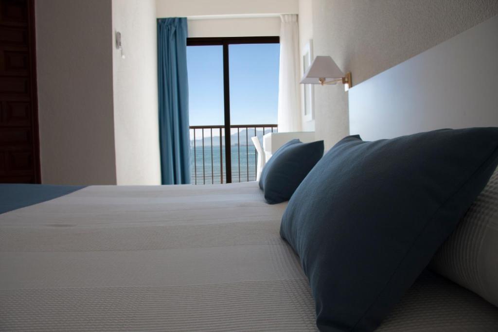 Postel nebo postele na pokoji v ubytování Hotel Sicania