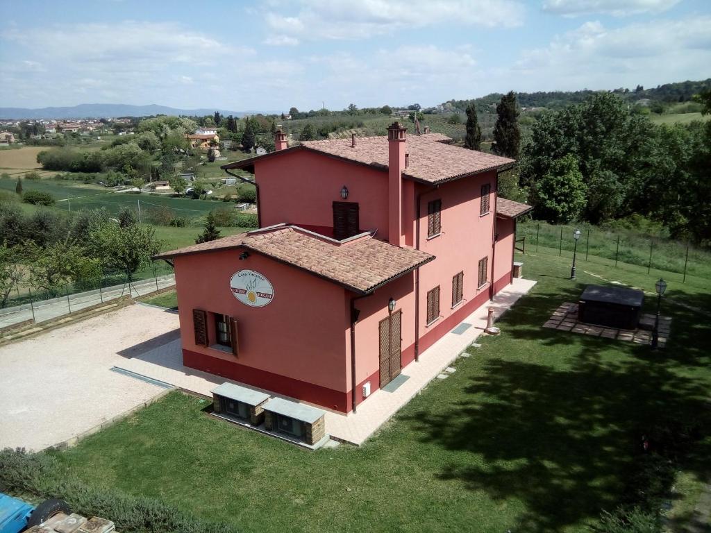 an aerial view of a small red house at La Bettola Tavern Rooms & Restaurant in Montopoli in Val dʼArno