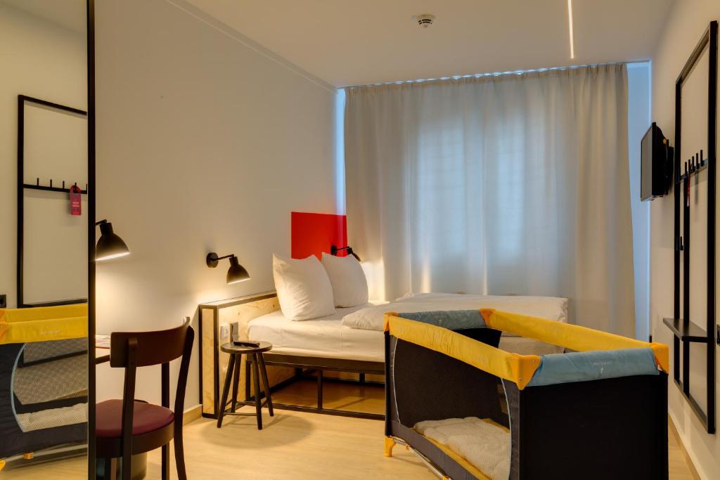 Postel nebo postele na pokoji v ubytování MEININGER Hotel Leipzig Hauptbahnhof