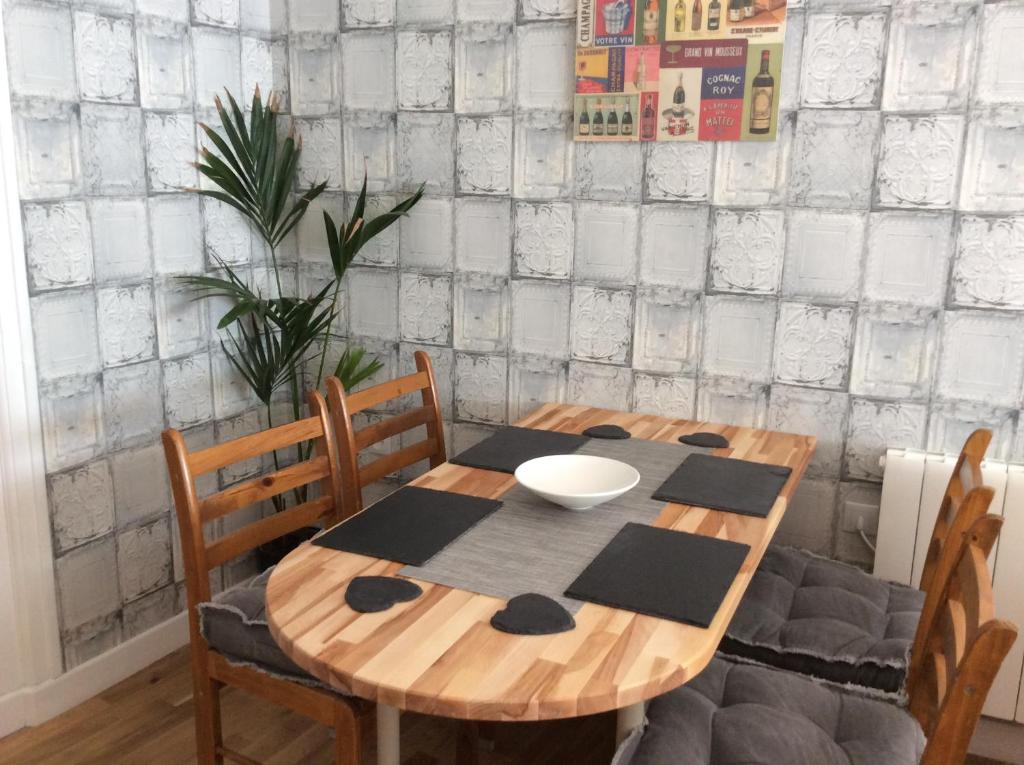 a wooden table with chairs and a bowl on it at Number 7 Gouarec in Gouarec