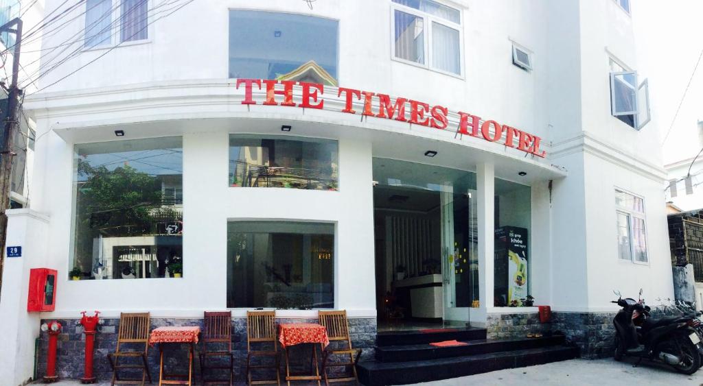 a white building with a red sign on it at The Times Hotel in Hue