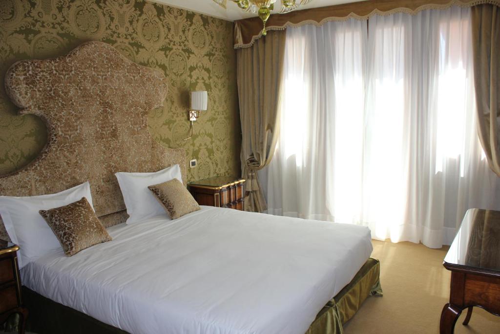 Postel nebo postele na pokoji v ubytování Hotel Casanova