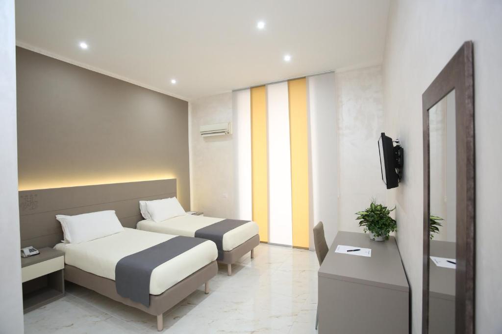 Postel nebo postele na pokoji v ubytování Hotel Vergilius Billia