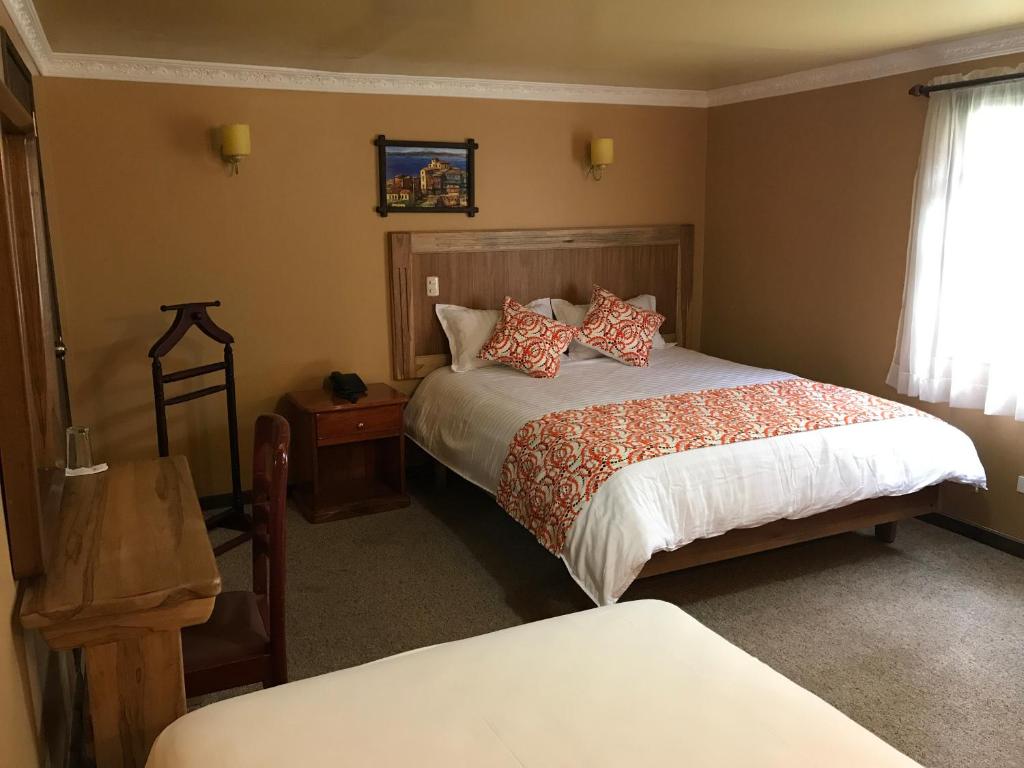 Postel nebo postele na pokoji v ubytování Hotel y Hosteria Natabuela