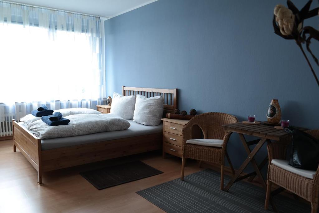 a bedroom with a bed and a table and a window at Wohnung mit traumhaften Weserblick in Bremen