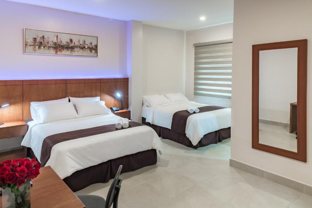 Postel nebo postele na pokoji v ubytování Hotel La Ría Durán