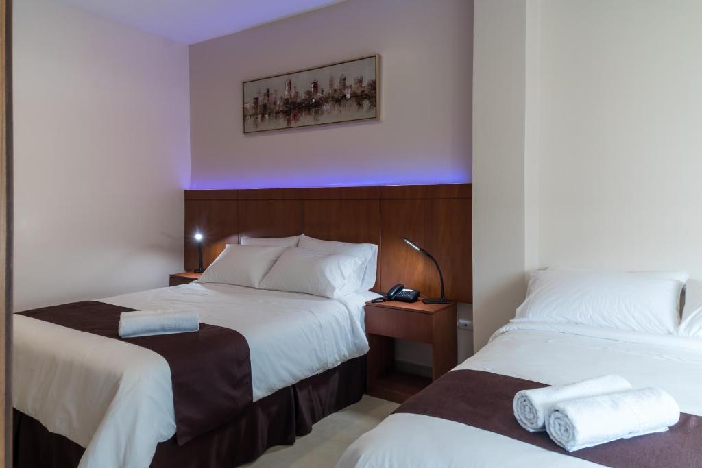 Postel nebo postele na pokoji v ubytování Hotel La Ría Durán
