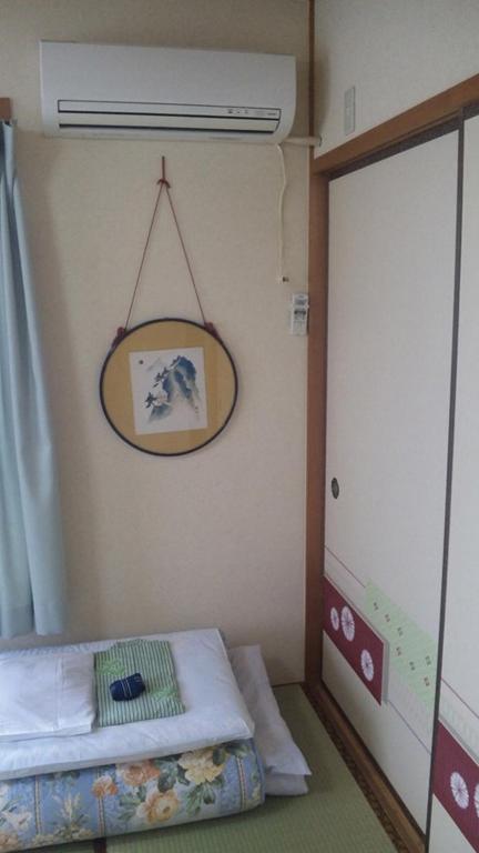 Postel nebo postele na pokoji v ubytování Mizuhokan