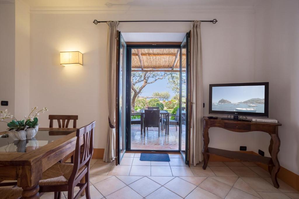 a dining room with a dining table and a sliding glass door at Tenuta Del Poggio Antico in Ischia