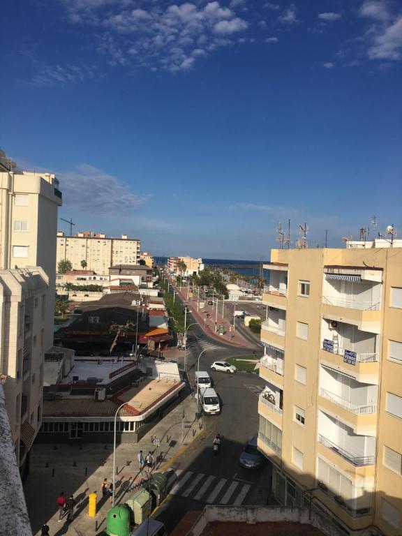 a city with buildings and the ocean in the background at Apartamento Puerto-Playa Gandia in Gandía