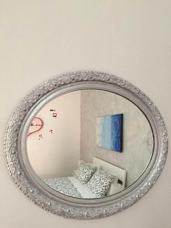 - un miroir mural avec un lit dans la chambre dans l'établissement La Rosa Blu 2, à Santeramo in Colle