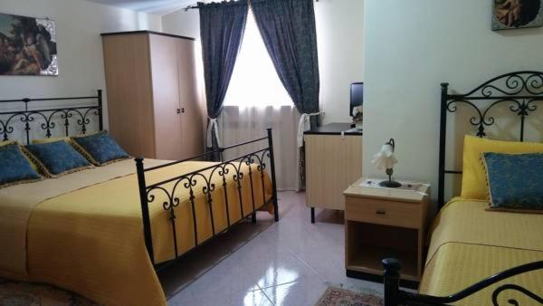 Postel nebo postele na pokoji v ubytování B&B Villa Lena