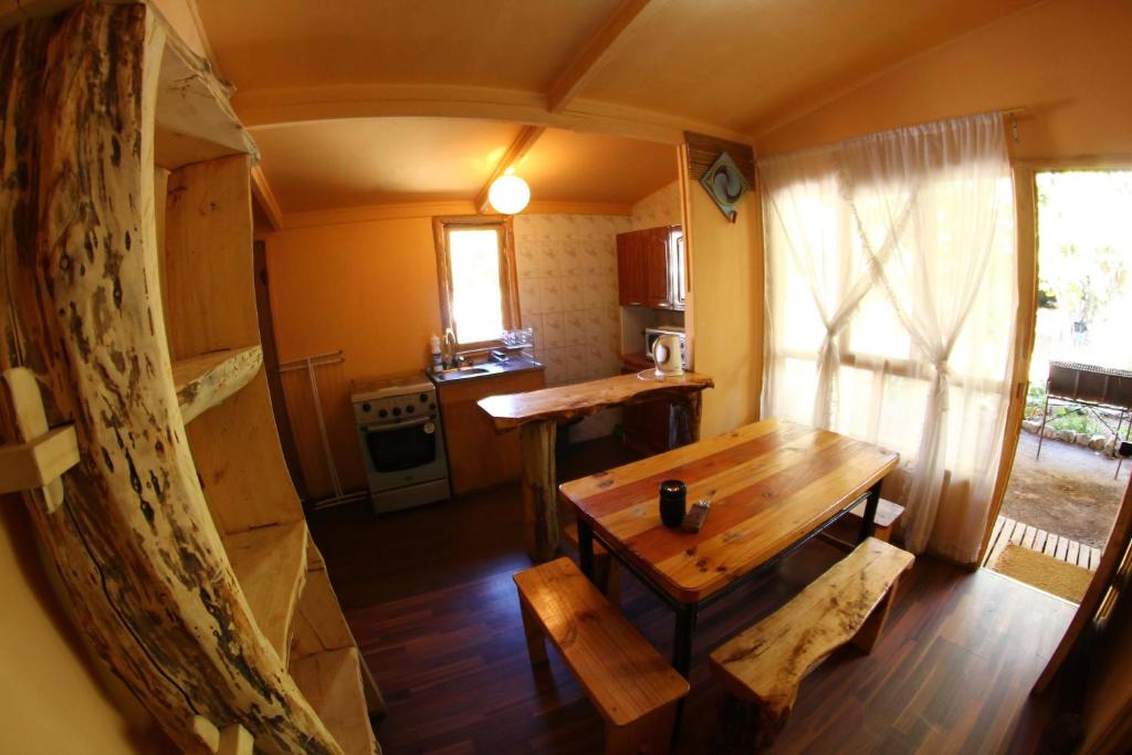 a kitchen with a wooden table in a room at Hostal Doña Ema in Pisco Elqui