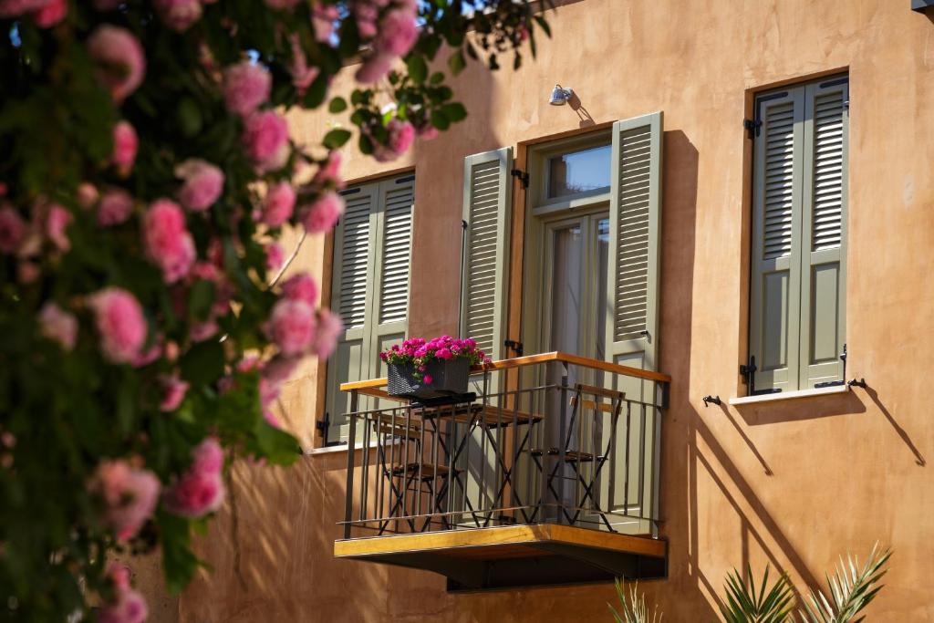 a building with a balcony with a flower pot on it at La Casa Piccola in Chania