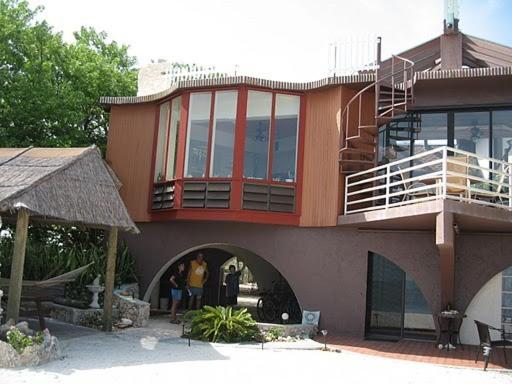 
a large brick building with a balcony and windows at The Barnacle B&B in Big Pine Key
