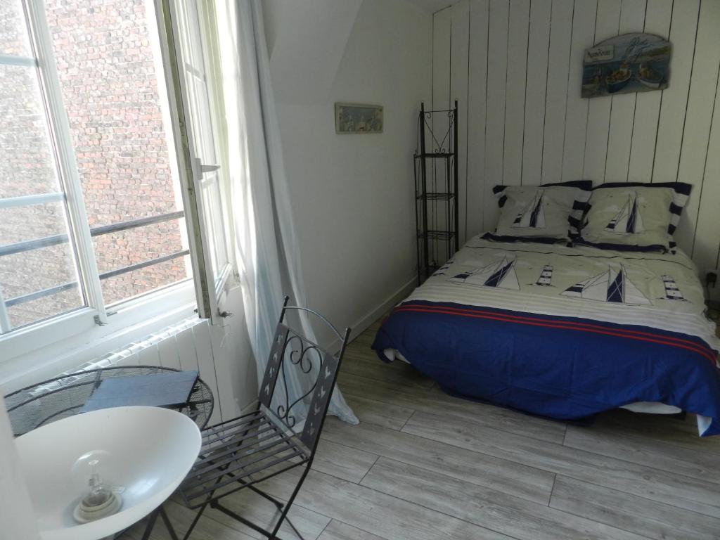 a bedroom with a bed and a sink in it at Appartement vue sur le port de Dieppe in Dieppe