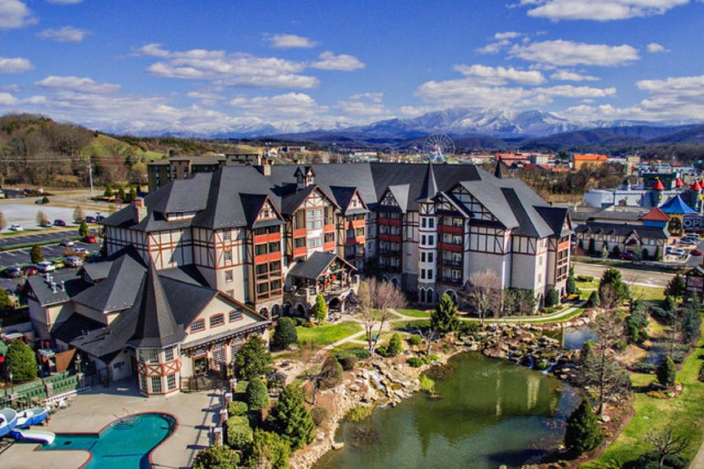 an aerial view of a resort with a river and buildings at The Inn at Christmas Place in Pigeon Forge
