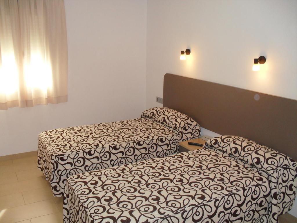 Postel nebo postele na pokoji v ubytování Hostal San Marcos