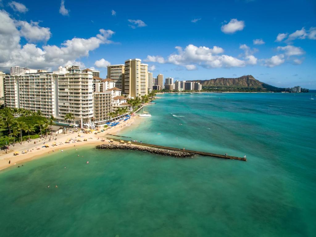 a view of a beach with buildings and the ocean at Waikiki Shore Beachfront in Honolulu