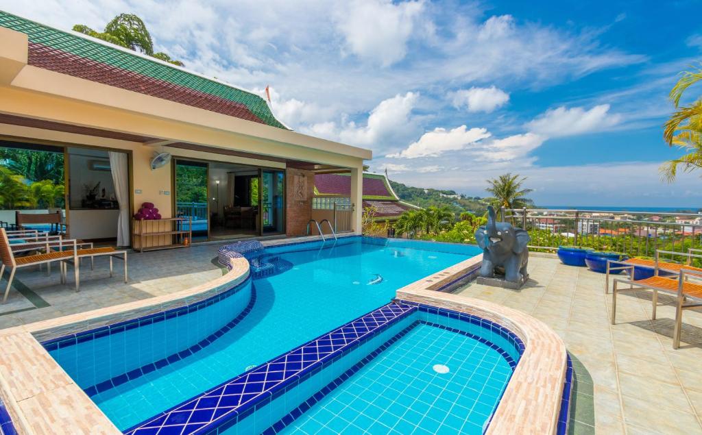 a swimming pool in front of a house at Sea View Luxury Villas Kata Beach in Kata Beach