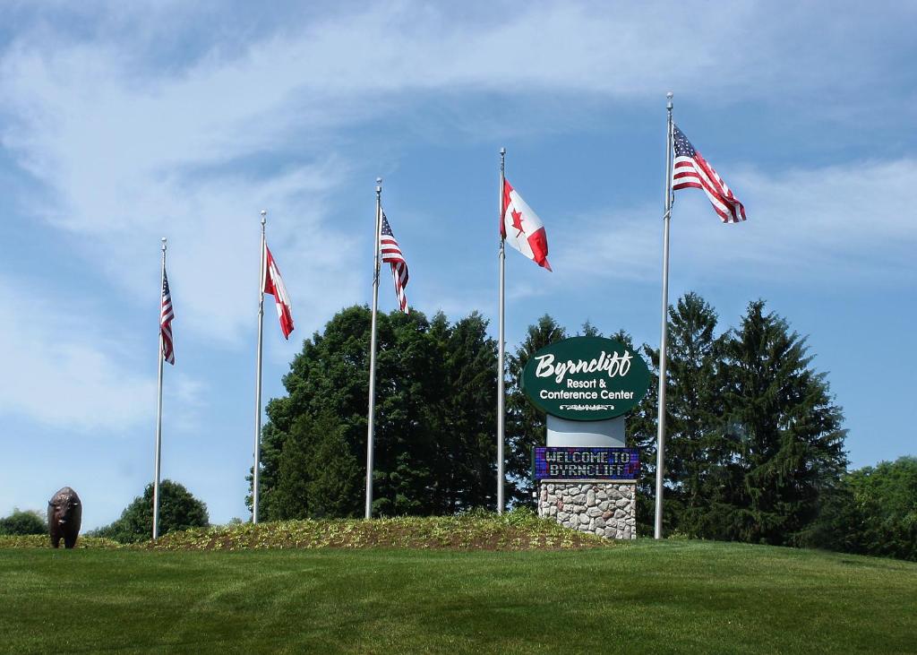 a sign with american flags on top of a field at Byrncliff Golf Resort in Varysburg