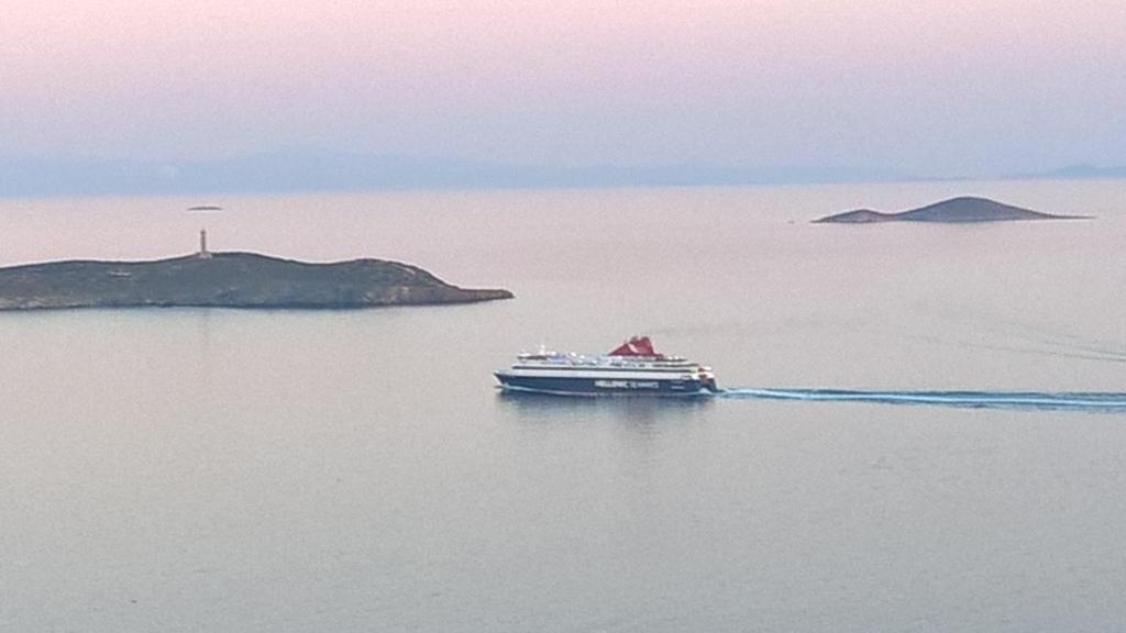 a cruise ship in a large body of water at Comfortable Home Ermoupolis in Ermoupoli