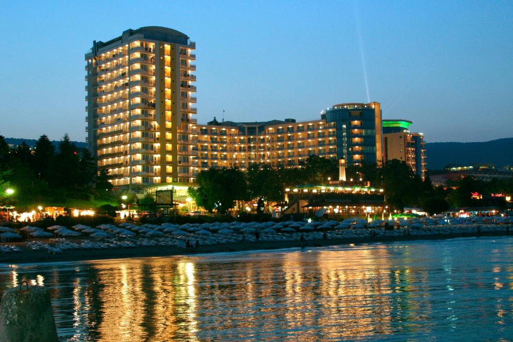 a large building next to a body of water at Bonita Hotel in Golden Sands