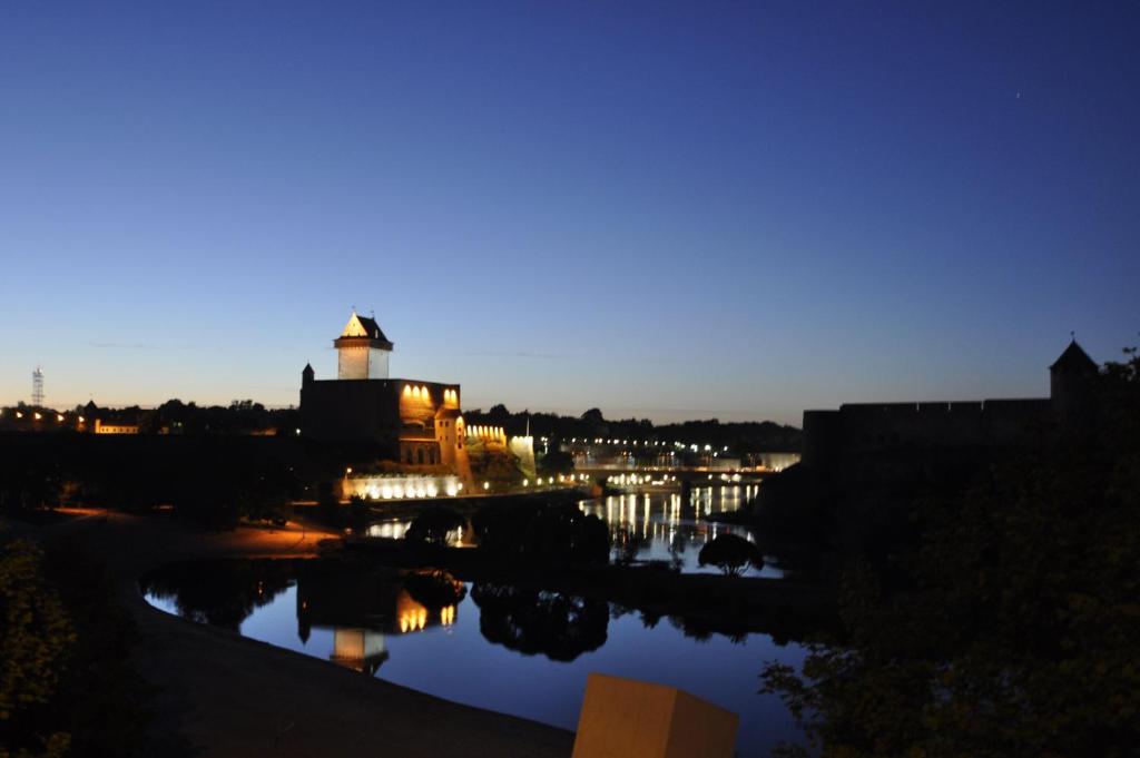 a view of a river at night with a lighthouse at Grafovi Apartments in Narva